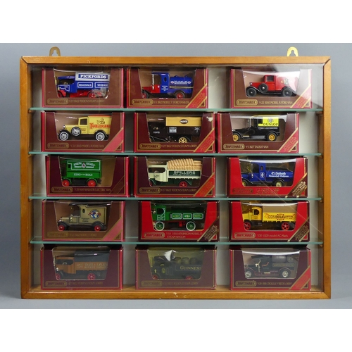 307 - Five wood and glass display cabinets housing Matchbox and Lledo die-cast vehicles in their boxes. Co... 