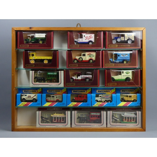 307 - Five wood and glass display cabinets housing Matchbox and Lledo die-cast vehicles in their boxes. Co... 