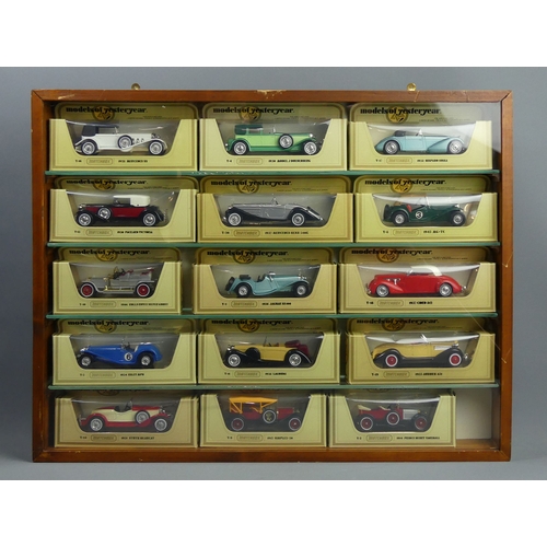 307 - Five wood and glass display cabinets housing Matchbox and Lledo die-cast vehicles in their boxes. Co... 