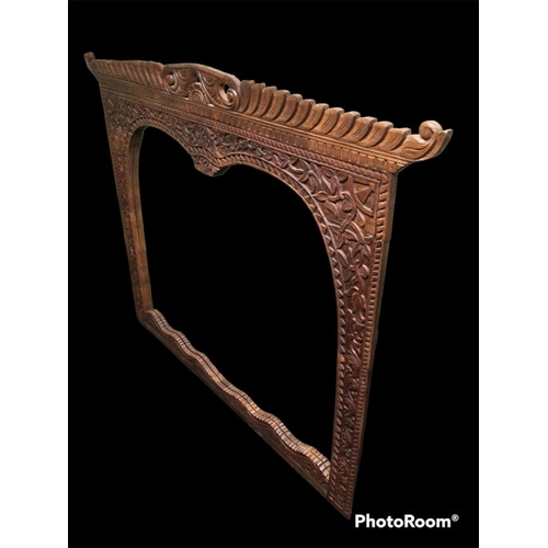 325 - A large ornately carved hardwood over mantle mirror. 152 x 121 cm. Collection only.