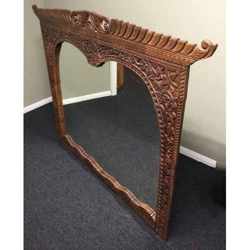 325 - A large ornately carved hardwood over mantle mirror. 152 x 121 cm. Collection only.