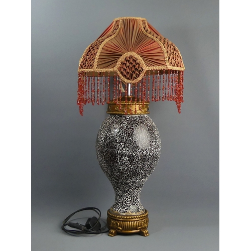 326 - An ornate black crackle glass and gilt wood table lamp with a silk shade. 71 cm high. Collection onl... 