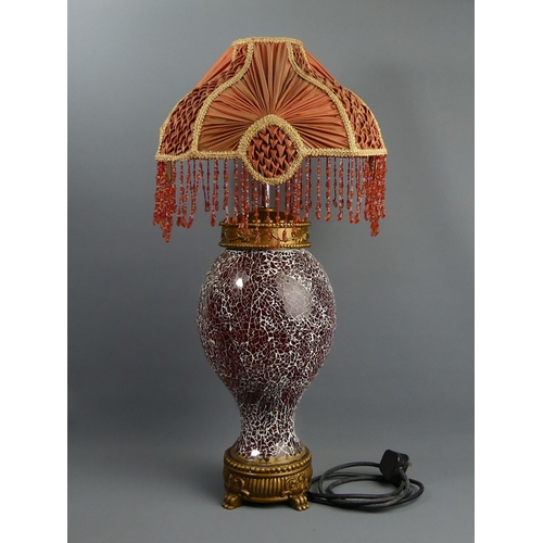 327 - An ornate red crackle glass and gilt wood table lamp with a silk shade. 71 cm high. Collection only.