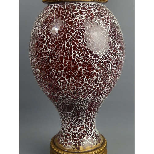 327 - An ornate red crackle glass and gilt wood table lamp with a silk shade. 71 cm high. Collection only.