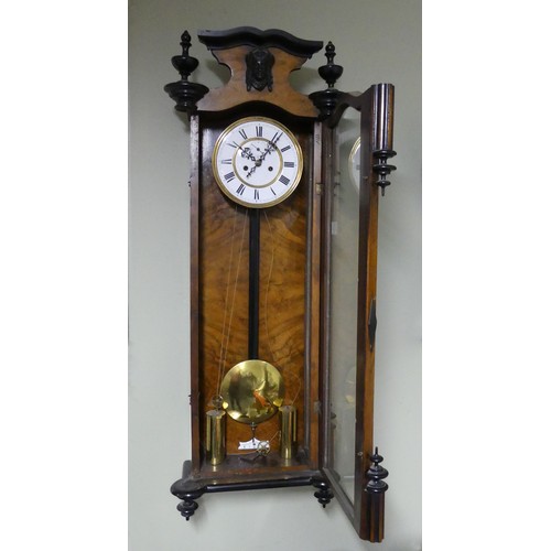 328 - A Victorian walnut and ebonised striking wall clock, complete with weights and key. 140 x 35 cm. Col... 