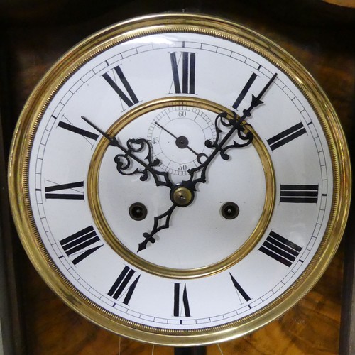 328 - A Victorian walnut and ebonised striking wall clock, complete with weights and key. 140 x 35 cm. Col... 