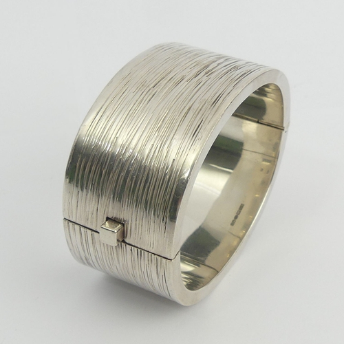 17 - Stylish Sterling silver textured finish hinged bangle, 114 grams. 30 mm wide. UK Postage £12.