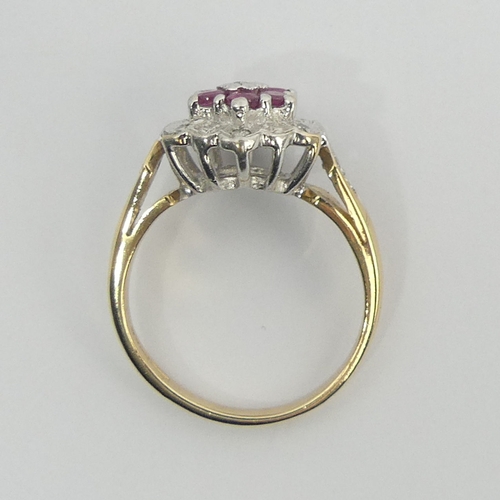 2 - 9ct gold ruby and diamond cluster ring, 3.1 grams. Size K, 11.7 mm. Uk Postage £12.