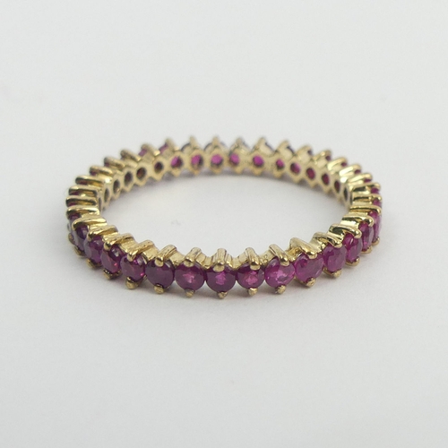 20 - 9ct gold ruby set full eternity ring, 2 grams. Size T, 3.25 mm wide. UK Postage £12.