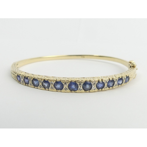 6 - 9ct gold sapphire and diamond hinged bangle, 14.4 grams. 5.4 mm at the widest point. Uk Postage £12.