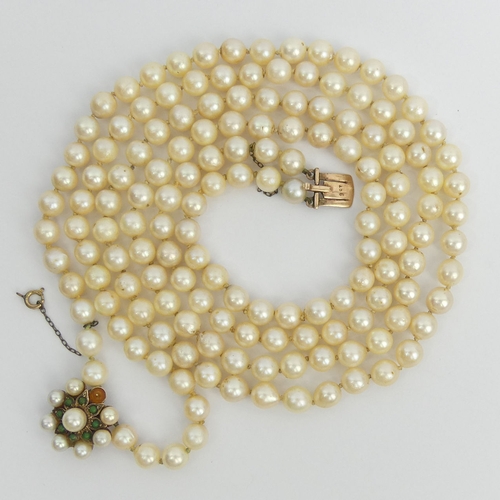 32 - Cultured pearl double strand necklace with a 9ct gold clasp, set with turquoise and pearls, 89 grams... 