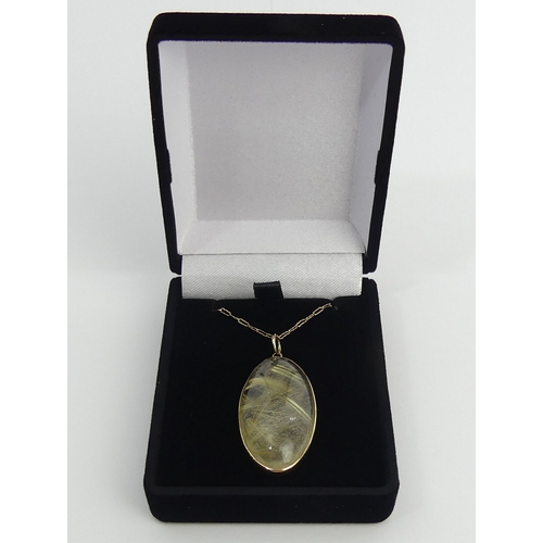 40 - 9ct gold reticulated quartz pendant and chain, 10.2 grams. Chain 65 cm, Pendant 44 mm. UK Postage £1... 