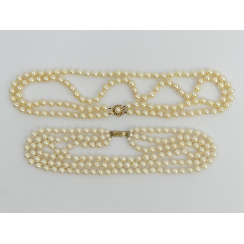 43 - A cultured pearl double strand necklace with a 9ct gold clasp and a faux pearl triple strand example... 