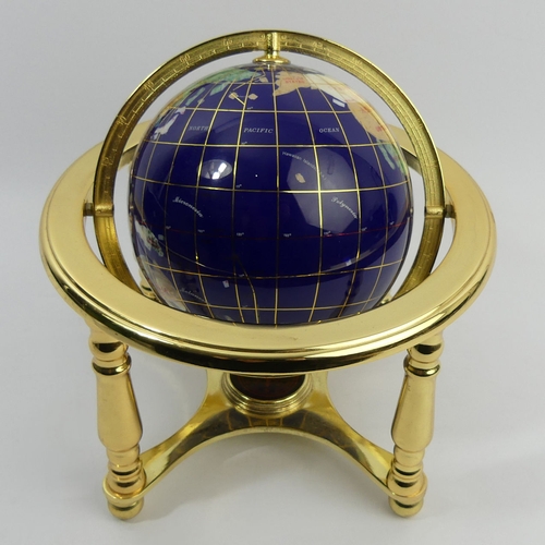 271 - A gilt metal table-top globe with compass inset to the base, 24 cm. UK Postage £14.