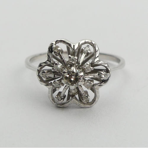 15A - 18ct white gold flower head design diamond set ring, 2.6 grams. Size P, 11.8 mm. UK Postage £12.