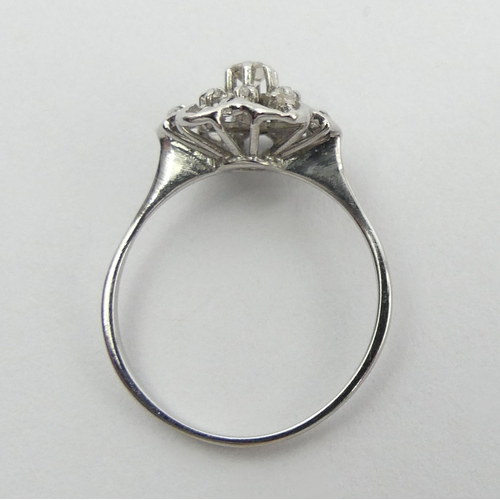 15A - 18ct white gold flower head design diamond set ring, 2.6 grams. Size P, 11.8 mm. UK Postage £12.