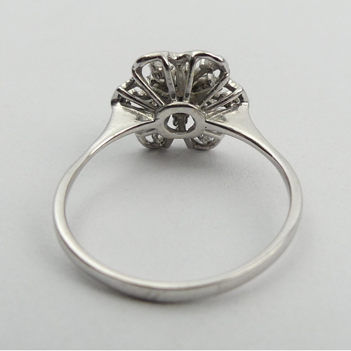 15A - 18ct white gold flower head design diamond set ring, 2.6 grams. Size P, 11.8 mm. UK Postage £12.