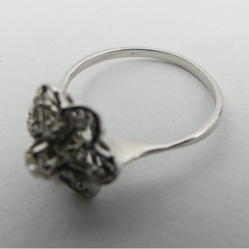 15A - 18ct white gold flower head design diamond set ring, 2.6 grams. Size P, 11.8 mm. UK Postage £12.