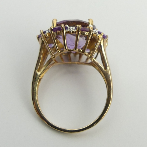 6 - 9ct gold amethyst and diamond cluster ring, 4.8 grams. Size N 1/2, 18.2 mm. UK Postage £12.