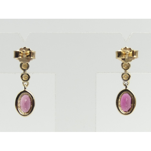 25 - A pair of 9ct gold rubellite and diamond earrings, 2 cm long. UK Postage £12.