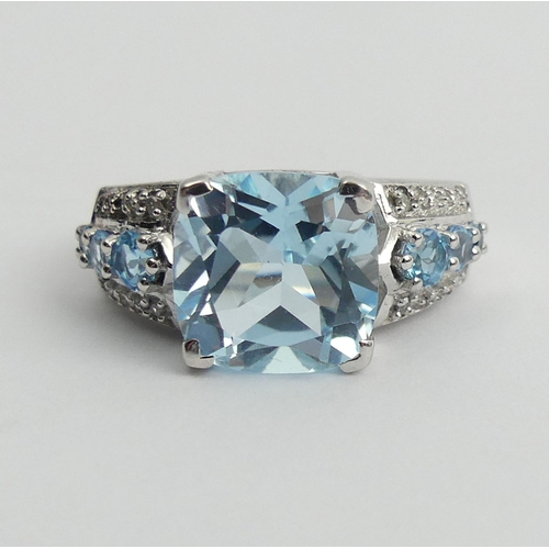 27 - Sterling silver blue topaz and diamond ring, 5 grams. Size N 1/2. UK Postage £12.