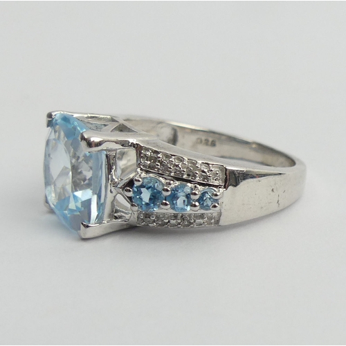 27 - Sterling silver blue topaz and diamond ring, 5 grams. Size N 1/2. UK Postage £12.