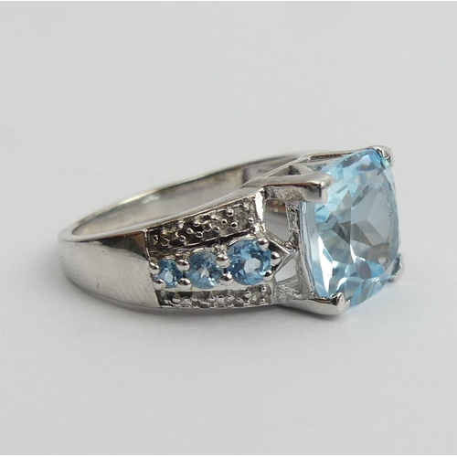 27 - Sterling silver blue topaz and diamond ring, 5 grams. Size N 1/2. UK Postage £12.