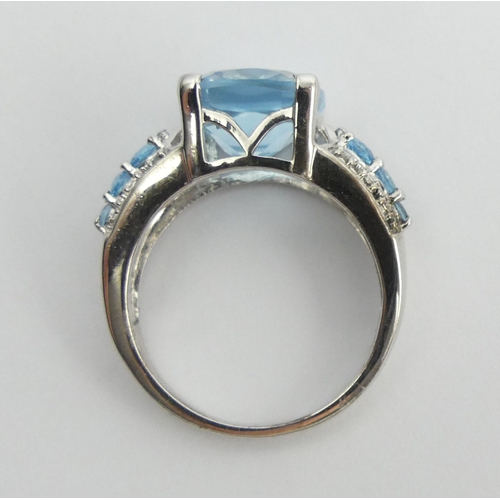 27 - Sterling silver blue topaz and diamond ring, 5 grams. Size N 1/2. UK Postage £12.