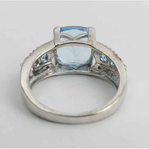 27 - Sterling silver blue topaz and diamond ring, 5 grams. Size N 1/2. UK Postage £12.