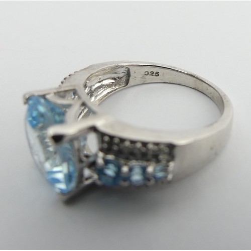 27 - Sterling silver blue topaz and diamond ring, 5 grams. Size N 1/2. UK Postage £12.