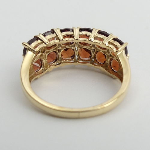 39 - 9ct gold garnet two row ring, 3.6 grams. Size N 1/2, 8.5 mm. UK Postage £12.