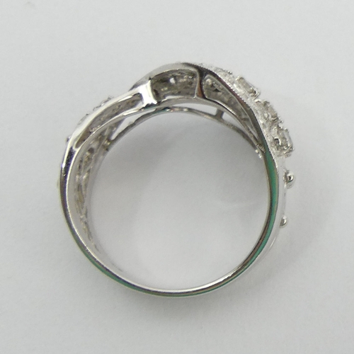 50A - Stylish design 18ct white gold diamond ring, 5.9 grams. Size N, 14.2 mm. UK Postage £12.