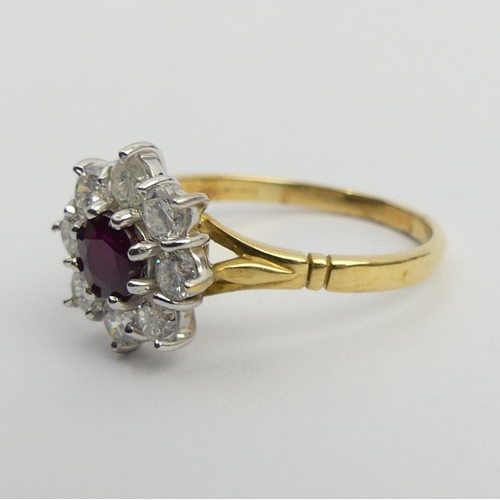 58 - 18ct gold ruby and diamond cluster ring, 4.9 grams. Size U, 13.4 mm. Centre stone approx 1/2ct, diam... 