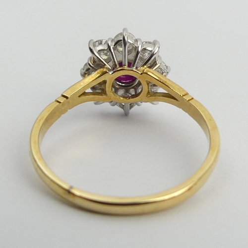 58 - 18ct gold ruby and diamond cluster ring, 4.9 grams. Size U, 13.4 mm. Centre stone approx 1/2ct, diam... 