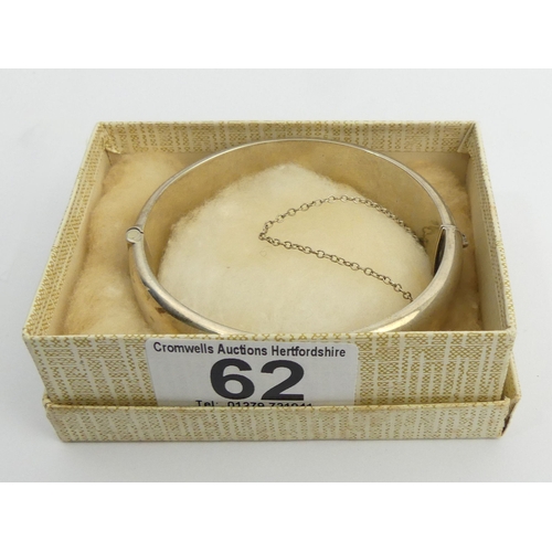 62 - Sterling silver engraved and hinged bangle, Birm.1979, 26.4 grams. 16 mm wide. UK Postage £12.