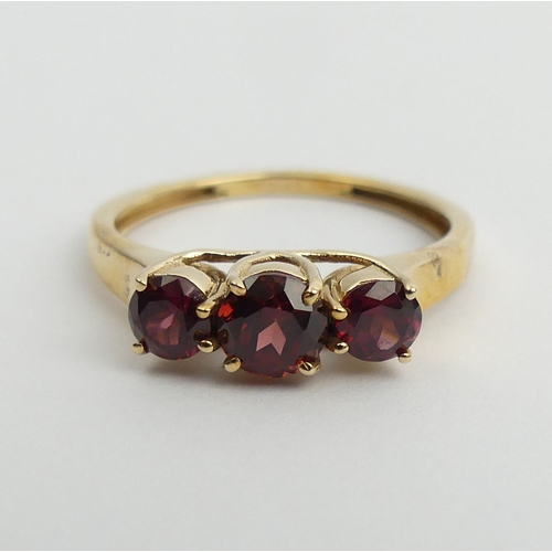 77 - 9ct gold rhodolite three stone ring, 2 grams. Size N 1/2, 5 mm wide. UK Postage £12.