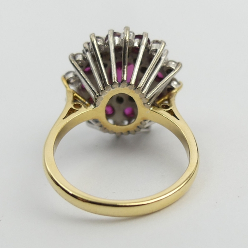 81 - 18ct gold ruby and diamond cluster ring, 7.6 grams. Size N, 18.6 mm wide. UK Postage £12.