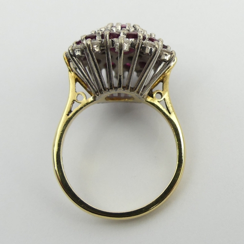 81 - 18ct gold ruby and diamond cluster ring, 7.6 grams. Size N, 18.6 mm wide. UK Postage £12.