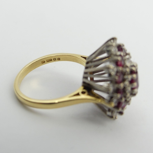 81 - 18ct gold ruby and diamond cluster ring, 7.6 grams. Size N, 18.6 mm wide. UK Postage £12.