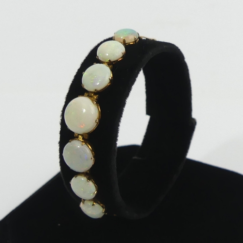 85A - Edwardian 9ct gold (tested) seven stone opal bracelet. 17 cm x 9 mm, 4.9 grams. UK Postage £12.