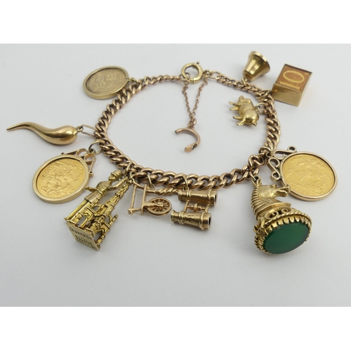 87 - 9ct gold charm bracelet with a 1900 and a 1911 half sovereign among other charms. 51 grams. UK Posta... 