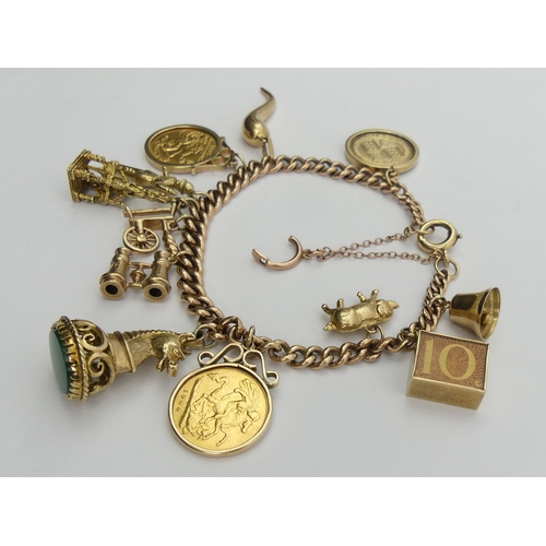 87 - 9ct gold charm bracelet with a 1900 and a 1911 half sovereign among other charms. 51 grams. UK Posta... 