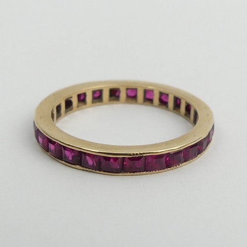 90 - 9ct gold (tested) ruby? full eternity ring, 2.1 grams. Size N 1/2, 2.8 mm. UK Postage £12.