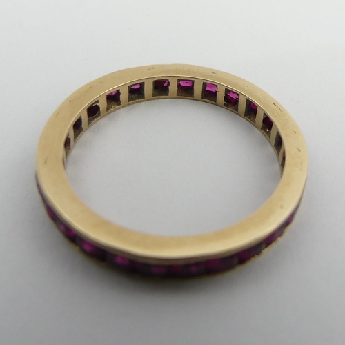 90 - 9ct gold (tested) ruby? full eternity ring, 2.1 grams. Size N 1/2, 2.8 mm. UK Postage £12.