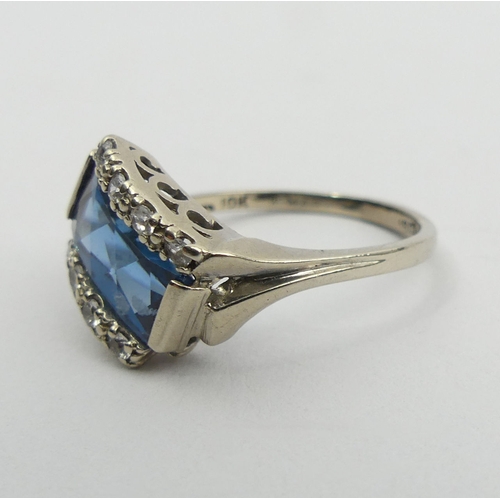 117 - 10ct white gold (ignore 18ct mark) blue and white paste set ring, 4.1 grams. Size T, 10.9 mm wide. U... 