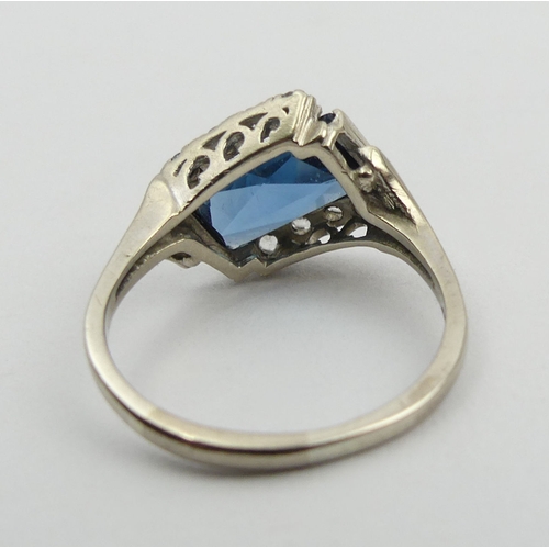 117 - 10ct white gold (ignore 18ct mark) blue and white paste set ring, 4.1 grams. Size T, 10.9 mm wide. U... 