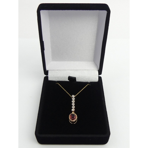 130 - 9ct gold rhodalite and diamond pendant and chain, 1.7 grams. Chain 44 cm, pendant 30 mm long. UK Pos... 