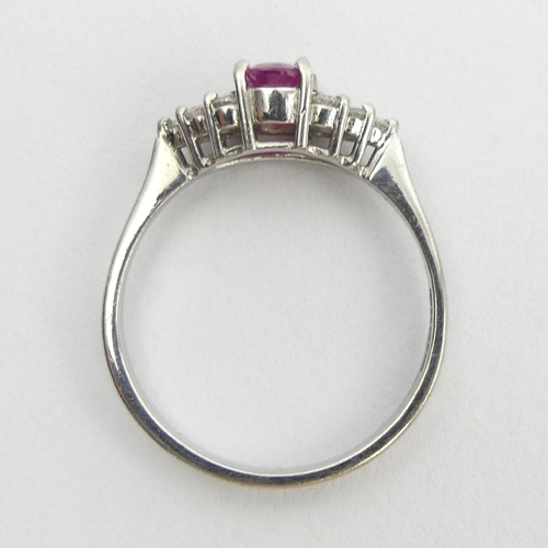 149 - 18ct white gold ruby and diamond ring, 3.5 grams. Size Q 1/2, 6 mm wide. UK Postage £12.