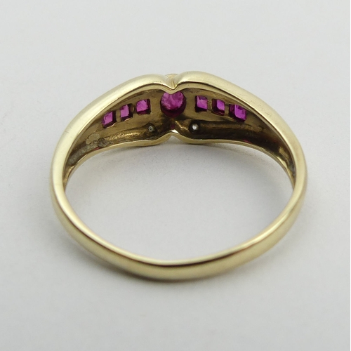 150A - 9ct gold seven stone ruby and diamond ring, 3.1 grams. Size U, 7.8 mm wide. UK Postage £12.