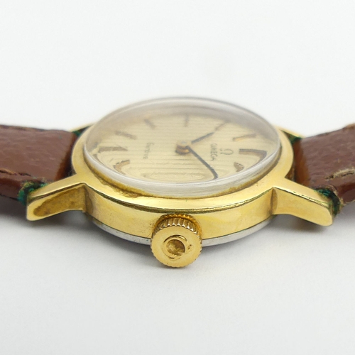 158 - Ladies Omega gold tone manual wind watch on a leather strap. 25 mm wide. UK Postage £12.
Condition r... 